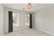 Neutral bedroom with two windows dressed with curtains, light walls, and carpet flooring at 3966 Creekview Ridge Dr, Buford, GA 30518