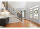 Inviting foyer featuring hardwood floors, staircase with iron spindles, and front door with sidelights at 3966 Creekview Ridge Dr, Buford, GA 30518