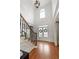 Elegant foyer with hardwood floors, a grand staircase, a decorative chandelier, and lots of natural light at 3966 Creekview Ridge Dr, Buford, GA 30518