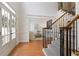 Bright foyer with hardwood floors, staircase with iron spindles, and views into the living room at 3966 Creekview Ridge Dr, Buford, GA 30518