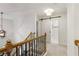 Upstairs hallway with wood and black iron railing and a barn door leading to a bathroom at 3966 Creekview Ridge Dr, Buford, GA 30518
