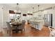 An open-concept kitchen and dining area features white cabinets, stainless steel appliances, and a large island with seating at 3966 Creekview Ridge Dr, Buford, GA 30518
