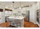 Modern kitchen with white cabinets, stainless steel appliances, a marble countertop island, and hardwood floors at 3966 Creekview Ridge Dr, Buford, GA 30518