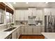 White kitchen with stainless steel appliances, marble countertops, and a herringbone backsplash at 3966 Creekview Ridge Dr, Buford, GA 30518