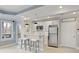 Basement kitchenette features white cabinetry, a bar, and stainless steel appliances at 3966 Creekview Ridge Dr, Buford, GA 30518