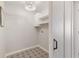 Laundry room with patterned floor tiles, shelves, and a sliding barn door at 3966 Creekview Ridge Dr, Buford, GA 30518