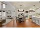 Open-concept living space connects a modern kitchen, a dining area, and a cozy living room at 3966 Creekview Ridge Dr, Buford, GA 30518