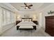 Serene main bedroom with a king-size bed, neutral decor, and lots of natural light from large windows at 3966 Creekview Ridge Dr, Buford, GA 30518