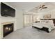 Elegant main bedroom features a fireplace, TV, and a luxurious king-size bed near bright windows at 3966 Creekview Ridge Dr, Buford, GA 30518