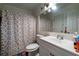 Bathroom featuring a sink, toilet and decorative leaf shower curtain at 703 Cypress Pointe St, Alpharetta, GA 30022