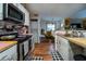 Cozy kitchen featuring black appliances, butcher block counters, and a washer/dryer at 703 Cypress Pointe St, Alpharetta, GA 30022