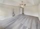 Large bedroom with plush carpet and white walls with doors leading to other rooms at 1200 Platinum Dr, Hoschton, GA 30548