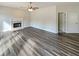 Spacious living room featuring LVP flooring, a ceiling fan, and a fireplace at 1200 Platinum Dr, Hoschton, GA 30548