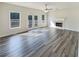 Bright and airy living room featuring a fireplace, hardwood floors, two windows, and french doors at 1200 Platinum Dr, Hoschton, GA 30548