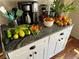 View of a countertop with fresh vegetables on display next to coffee machine at 1430 New Hope Church Rd, Loganville, GA 30052