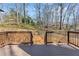 Wooden back deck overlooking the backyard, surrounded by a wooded landscape at 1521 Bentcreek Dr, Marietta, GA 30062