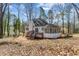 Backyard view of house with deck, screened-in porch and lush surrounding landscape at 1521 Bentcreek Dr, Marietta, GA 30062