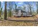 Backyard view of house with deck, screened-in porch and lush surrounding landscape at 1521 Bentcreek Dr, Marietta, GA 30062