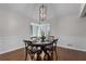 Elegant dining room features a table set for four, large window, wainscoting and chandelier lighting at 1521 Bentcreek Dr, Marietta, GA 30062