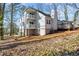 Two-story home's backyard features a large deck and screened in porch and white siding at 1521 Bentcreek Dr, Marietta, GA 30062