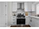 This kitchen features white cabinets, quartz countertops, stainless steel appliances, and a gas range with stainless steel hood at 1521 Bentcreek Dr, Marietta, GA 30062