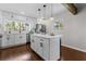 Bright kitchen with white cabinetry, quartz countertops, a center island, stainless steel appliances, and dark hardwood floors at 1521 Bentcreek Dr, Marietta, GA 30062