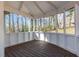 Bright screened-in porch with stained wood floors surrounded by views of backyard at 1521 Bentcreek Dr, Marietta, GA 30062