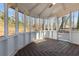 Bright screened-in porch with stained wood floors and white trim, great for entertaining at 1521 Bentcreek Dr, Marietta, GA 30062