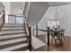 Staircase leading to the second floor, next to the dining room with hanging light fixture at 1521 Bentcreek Dr, Marietta, GA 30062