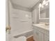 Bright white bathroom features a shower-tub combo with a single sink vanity at 2390 Morgan Ne Rd, Marietta, GA 30066