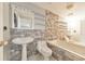 Full bathroom with brick-style wall, pedestal sink, bathtub and tiled floor at 2390 Morgan Ne Rd, Marietta, GA 30066