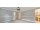 Spacious bedroom boasts neutral walls, modern light fixture, and doorways to other rooms at 2390 Morgan Ne Rd, Marietta, GA 30066