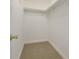 Walk-in closet featuring carpeted floors, white walls, and shelving for optimal storage at 2390 Morgan Ne Rd, Marietta, GA 30066