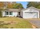 Charming one-story home with a white exterior, lush green lawn, and a driveway at 2390 Morgan Ne Rd, Marietta, GA 30066