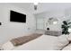 Serene bedroom with a ceiling fan, dresser, and a mounted TV for modern comfort at 3096 Highland Se Dr, Smyrna, GA 30080