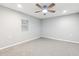 Neutral bedroom featuring plush carpet, a ceiling fan, and a window at 555 N Lake N Dr, Covington, GA 30016