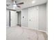 Neutral bedroom featuring plush carpet, ceiling fan, and view of an adjoined room at 555 N Lake N Dr, Covington, GA 30016