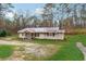 Charming single-story home with neutral siding, dark shutters, and a cozy covered front porch at 555 N Lake N Dr, Covington, GA 30016