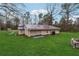 Home exterior with a lush backyard and a dark metal roof at 555 N Lake N Dr, Covington, GA 30016