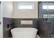 Contemporary bathroom showcases a standalone tub with modern dark tile and sleek fixtures at 916 Ira Sw St, Atlanta, GA 30310