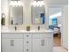 Bathroom featuring double sinks and white cabinets with views of the main bedroom at 916 Ira Sw St, Atlanta, GA 30310