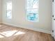 Room with wood floors features a light, airy atmosphere enhanced by large windows and natural light at 916 Ira Sw St, Atlanta, GA 30310