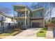 Modern two-story home with green siding, brick accents, and a two-car garage at 916 Ira Sw St, Atlanta, GA 30310