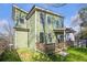 Inviting home exterior with green siding, a deck, and a well-maintained lawn at 916 Ira Sw St, Atlanta, GA 30310