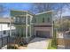 Modern two-story home with green siding, brick accents, and a two-car garage at 916 Ira Sw St, Atlanta, GA 30310