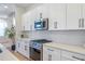 Modern kitchen featuring quartz countertops, stainless steel appliances, and white cabinetry at 916 Ira Sw St, Atlanta, GA 30310