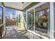 Covered porch with wooden decking and sliding glass doors to the dining area, offering indoor/outdoor living at 916 Ira Sw St, Atlanta, GA 30310