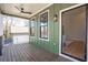 Covered porch with wood flooring, a ceiling fan, black railing and vertical siding provides pleasant outdoor living at 916 Ira Sw St, Atlanta, GA 30310