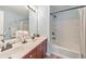 Bright bathroom with a double sink vanity, large mirror, and a shower-tub combination at 2415 Clock Face Ct, Lawrenceville, GA 30043