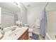 Well-lit bathroom featuring tile flooring, a shower-tub combination, and vanity at 2415 Clock Face Ct, Lawrenceville, GA 30043